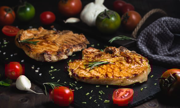 Grilled beef steak with spices on a stone background photo