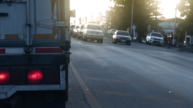 Brake light of truck car on the road  with many cars blocking traffic signals across the street. Stop by traffic light condition. photo