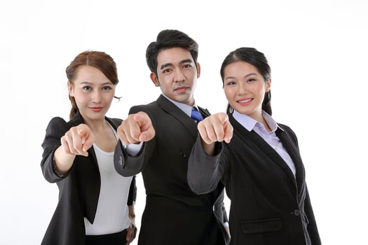 Southeast Asian young office business man woman wearing suit point finger at camera on white studio background photo