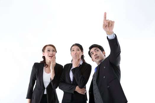 Southeast Asian young office business man woman wearing suit point finger showing up expressions surprise wonder wow on white studio background photo