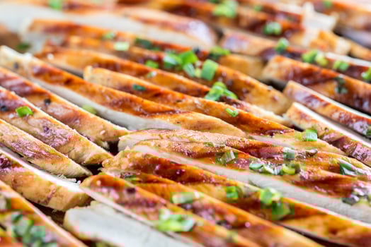 Slices of grilled chicken in lime sauce photo