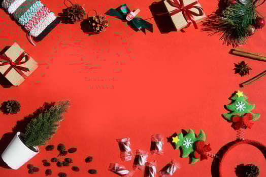 Christmas background with Xmas gifts and candy canes on red. flat lay. Space for text photo