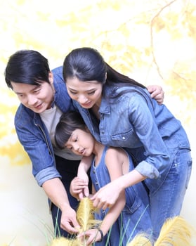 South East Asian young father mother daughter  parent girl child activity indoor photo