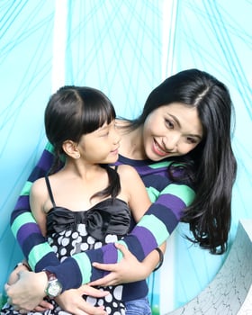South East Asian young father mother daughter  parent girl child activity indoor photo