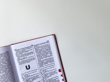 Yogyakarta, Indonesia, 26 Jan 2023 - A book full of Indonesian vocabulary, open on a white table. photo