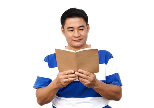 Handsome Asian man holds book to read. Concept , Relax time, pastime, hobby. Give time for yourself to read books , magazine, novels. Reading in daily life. Education ,knowledge or  pleasure. photo