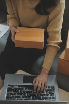 Business woman start up small business entrepreneur SME success .freelance woman working at home with Online Parcel delivery. SME and packaging deliveryconcept photo