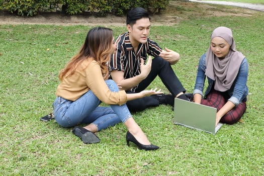 Young Asian different ethnic malay chinse  man woman activity lifestyle student educating job business sit on grass discuss photo