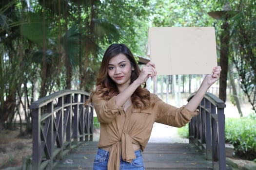 Young Asian Malay man woman outdoor green park walk talk discuss mingle photo