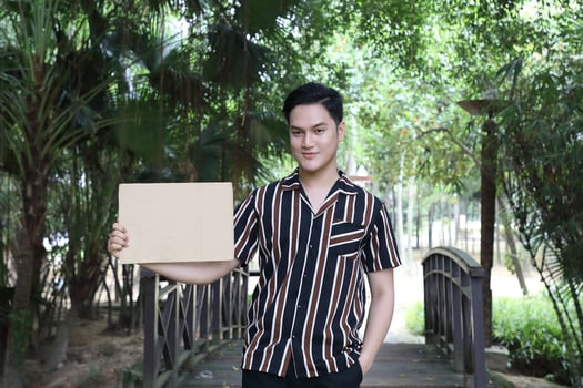 Young Asian Malay man woman outdoor green park walk talk discuss mingle photo