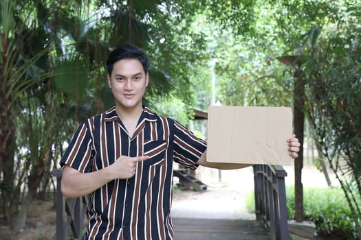 Young Asian Malay man woman outdoor green park walk talk discuss mingle photo