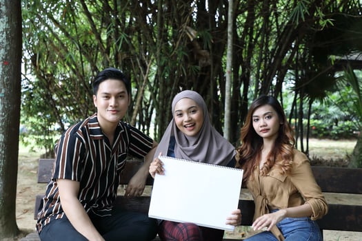Young Asian Malay man woman outdoor green park walk talk discuss mingle photo