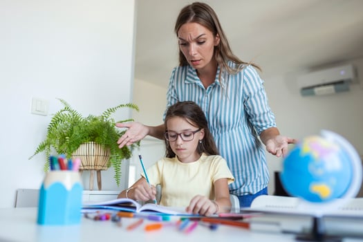 Stressed mother and son frustrated over failure homework, school problems concept. Sad little girl turned away from mother, does not want to do boring homework photo