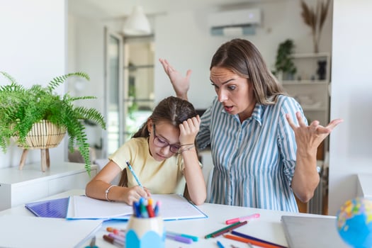 Do not ignore me when I am talking. Moms helping with homework. Mom is angry because her daughter dont want to do homework. Stressed mother and daughter frustrated over failure homework. photo