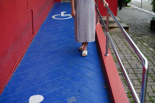 Asian elderly old woman patient use support rail on ramp, handrail safety grab bar, security in nursing hospital. photo