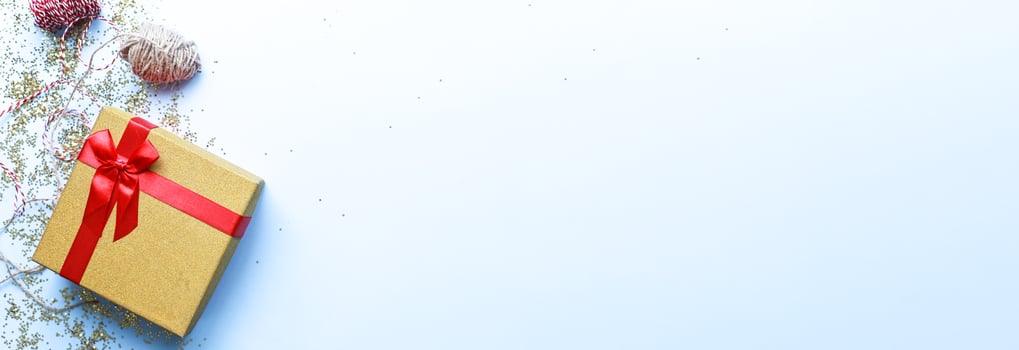 Banner Gift wrapping. Christmas present on a blue background. Glitter, shine photo