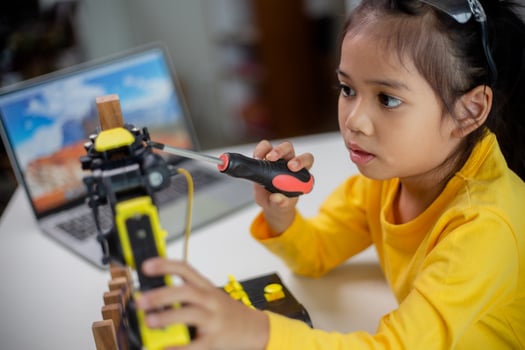STEM education concept. Asian students learn at home by coding robot arms in STEM, mathematics engineering science technology computer code in robotics for kids' concepts. photo