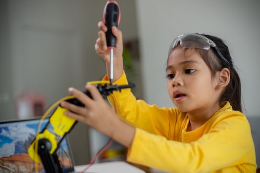 STEM education concept. Asian students learn at home by coding robot arms in STEM, mathematics engineering science technology computer code in robotics for kids' concepts. photo