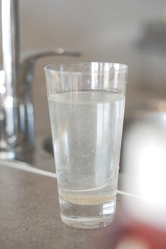 dirty glass of water on table photo