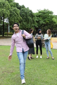Young asian malay chinese man woman outdoor park  book file folder laptop computer phone sit stand study mingle photo