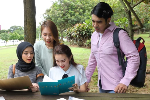 Young asian malay chinese man woman outdoor park  book file folder laptop computer phone sit stand study mingle photo