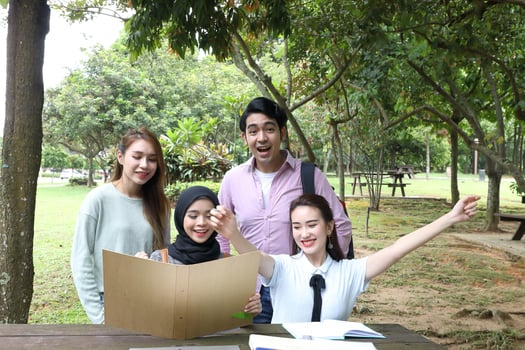 Young asian malay chinese man woman outdoor park  book file folder laptop computer phone sit stand study mingle photo