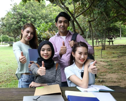 Young asian malay chinese man woman outdoor park  book file folder laptop computer phone sit stand study mingle photo