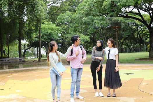 Young asian malay chinese man woman outdoor park walk stand study talk discuss point laptop file book backpack photo