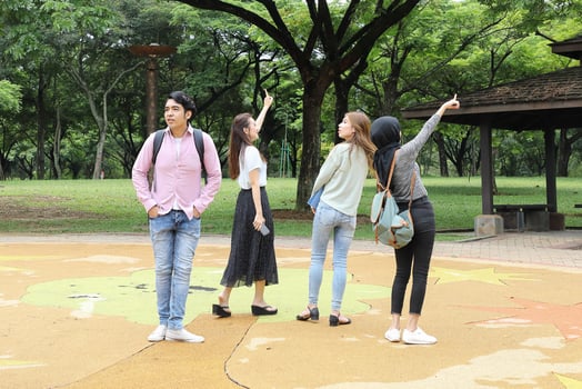 Young asian malay chinese man woman outdoor park walk stand study talk discuss point laptop file book backpack photo