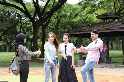 Young asian malay chinese man woman outdoor park walk stand study talk discuss point laptop file book backpack mingle fun meet greet photo