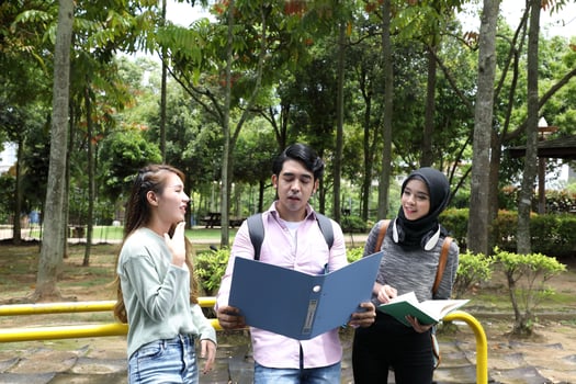 Young asian malay chinese man woman indoor stair corridor campus book file folder laptop computer phone sit stand study mingle photo