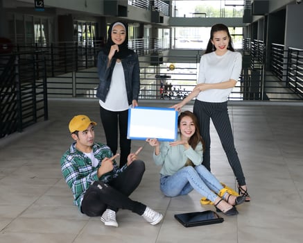 Young asian malay chinese man woman indoor stair corridor campus book file folder laptop computer phone sit stand study mingle photo