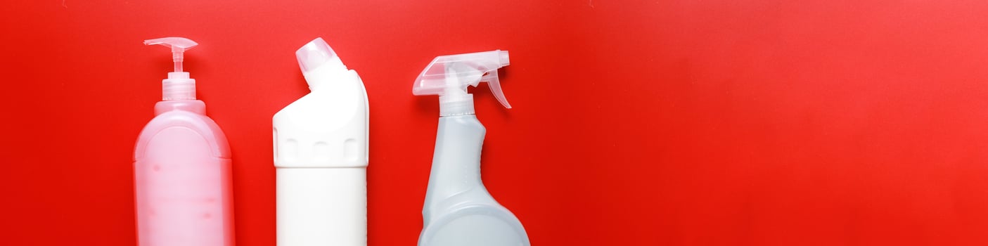 Banner Flat lay cleaning products on a red background. Cleaning bottle mockup photo