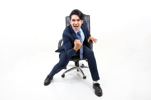 South east Asian Malay Man facial expression sit on chair confident victory successful photo