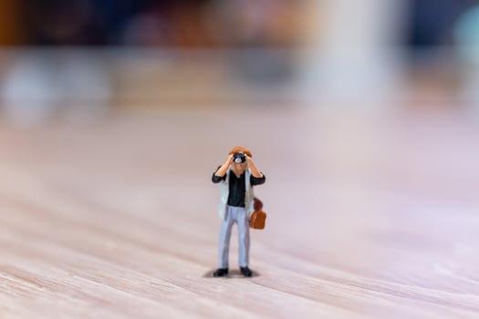 Miniature people Photography holding a camera and copy space for text photo
