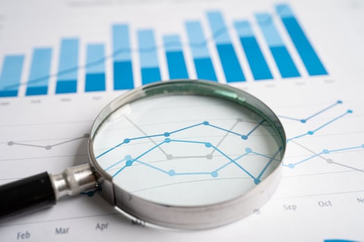 Magnifying glass on graph paper. Financial development, Banking Account, Statistics, Investment Analytic research data economy, Business concept. photo