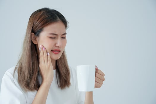 Asian woman feel sensitive teeth after drinking hot, female suffer tooth, decay problems, dental care, tooth extraction, decay problem, bad breath, Gingival Recession, Oral Hygiene instruction photo