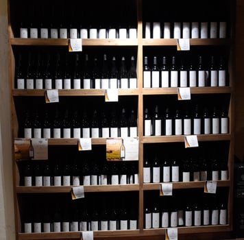 Shelves with wine and champagne in the store winery. Counter at the winery. photo