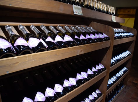 Shelves with wine and champagne in the store winery. Counter at the winery. photo