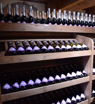 Shelves with wine and champagne in the store winery. Counter at the winery. photo