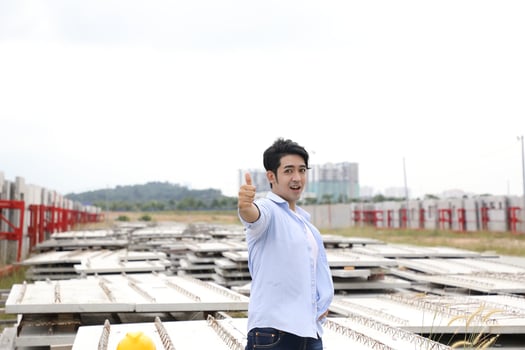 Asian man malay worker engineer management at construction site hard safety hat helmet thumbs up photo