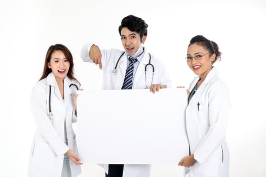Asian Chinese Malay male female doctor holding posing showing pointing blank expression happy exited white paper board on white background photo
