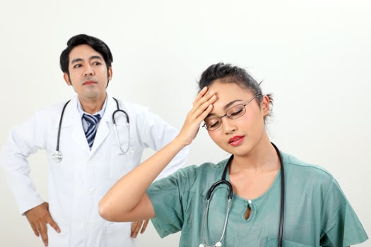 young asian malay chinese male female doctor on white background headache angry annoyed hand on head photo