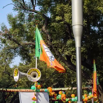 New Delhi, India - May 16 2023 - Bharatiya Janata Party Flag of Indian political party, BJP Bhartiya Janta Party Flag Waving during PM road show in Delhi, India photo