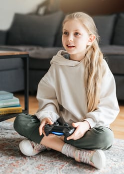 Girl playing video game at home photo