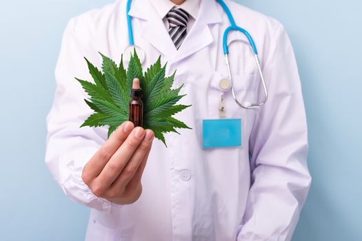 Doctor hand hold and offer to patient medical marijuana oil. Medical cannabis recipe for personal use. Alternative Medicine concept. photo
