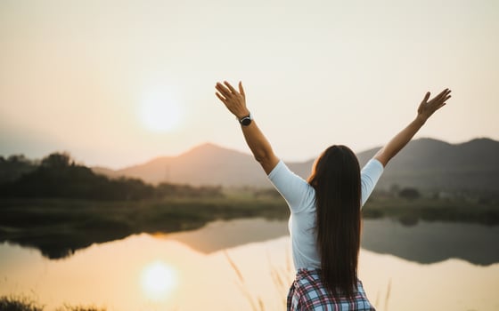 Happy woman spreading arms and watching the mountain. Travel Lifestyle success concept adventure active vacations outdoor freedom emotions. photo