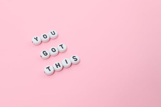 Top view of you got this quotes made out of beads on pastel background. motivation and success concept photo