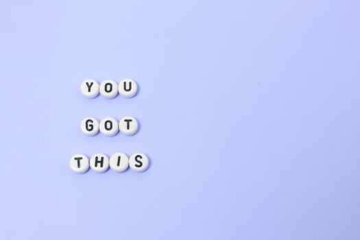 Top view of you got this quotes made out of beads on pastel background. motivation and success concept photo