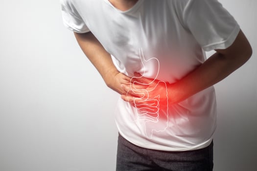 man having abdominal pain on white background photo